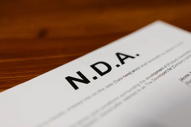 Focused close-up of an NDA document on a wooden desk, highlighting contract details. DBA registration: a source-based guide for 2027