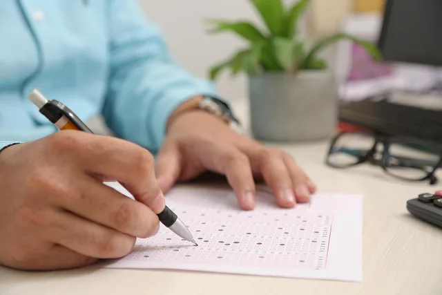 test paper, answering, hand, note, filling sheet, filling form, test paper, test paper, test paper, test paper, test paper. LLC S Corp Election Deadline and Rules: When It Beats Default Tax Status