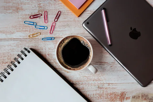 wood, desk, office, business, cup, coffee, coffee cup, notebook, notepad, pen, tablet, ipad. Sole Proprietorships Guide: Five LLC Decision Triggers